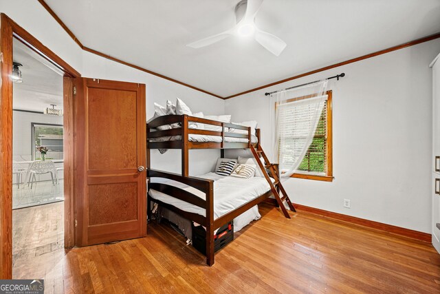 office space featuring crown molding, light hardwood / wood-style floors, and ceiling fan