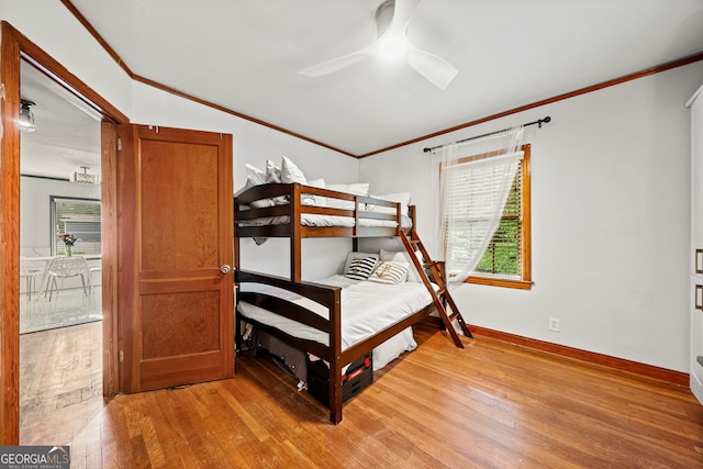 bedroom featuring ornamental molding, ceiling fan, and light wood-type flooring