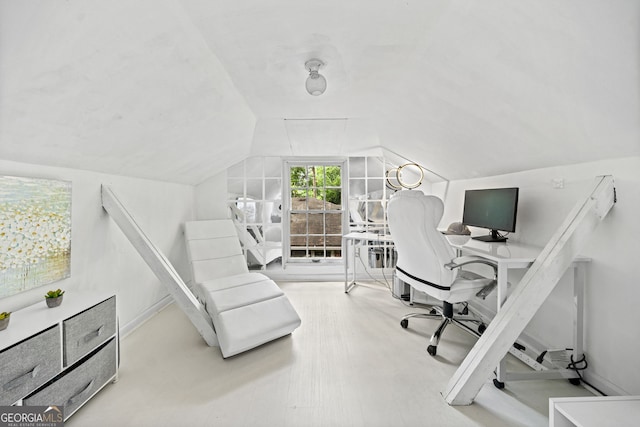 office area with vaulted ceiling and hardwood / wood-style floors