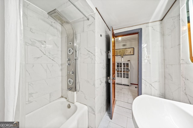 bathroom featuring tile walls and shower / bath combo