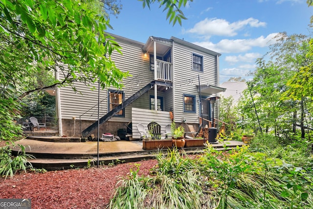 rear view of property with a balcony