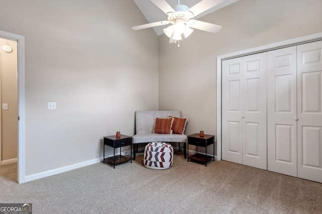 sitting room featuring light carpet, vaulted ceiling, and ceiling fan