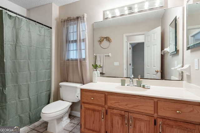 bathroom featuring tile patterned flooring, vanity, a textured ceiling, and toilet