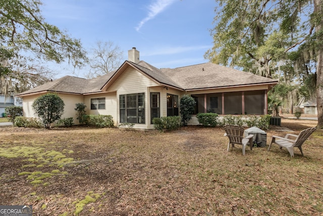 rear view of house featuring a sunroom