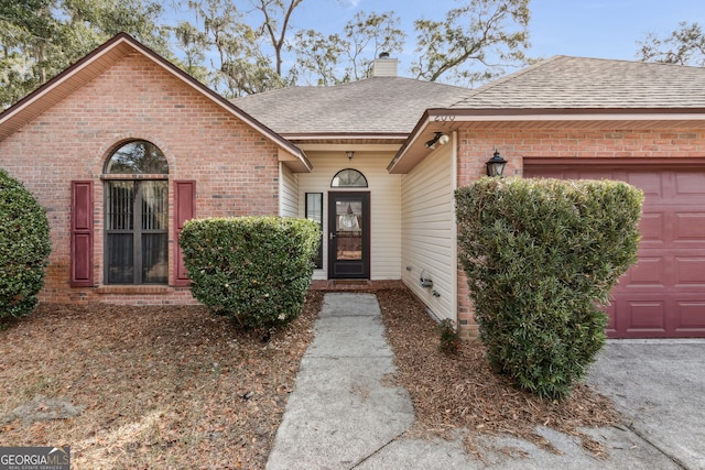 view of exterior entry with a garage