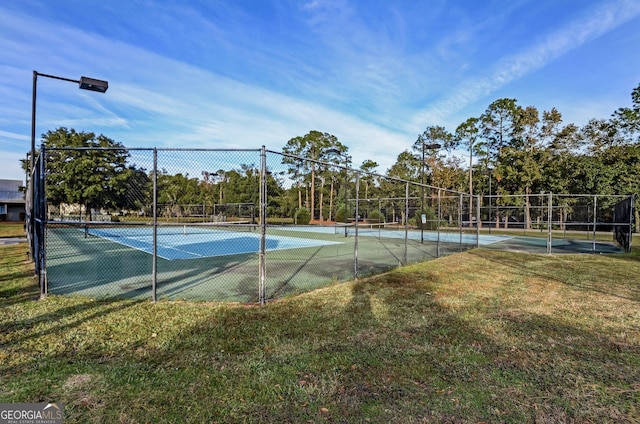 view of sport court featuring a yard