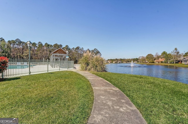 view of yard featuring a water view and a fenced in pool