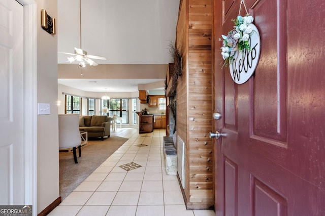 tiled entryway with ceiling fan