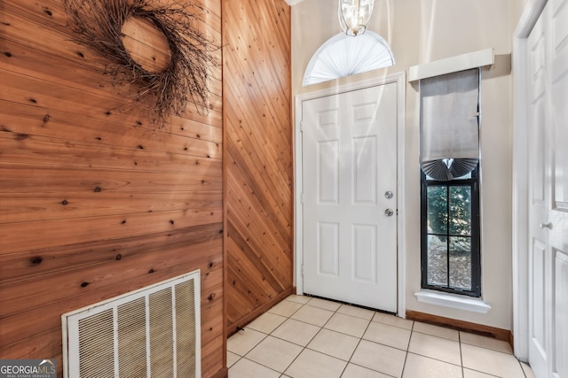 tiled entrance foyer with wood walls