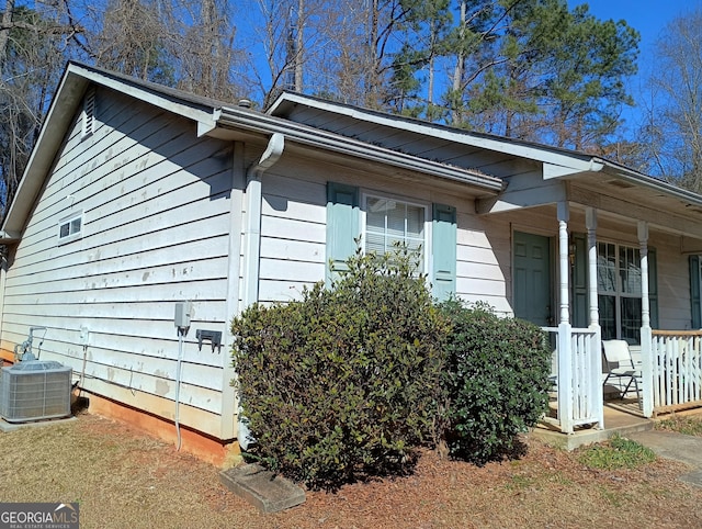 view of property exterior featuring cooling unit and covered porch