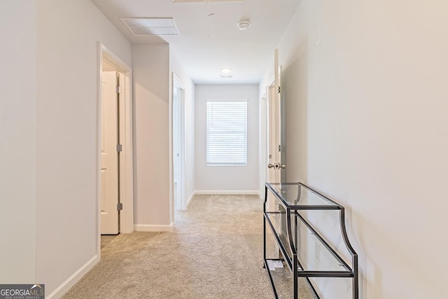 hall featuring light colored carpet