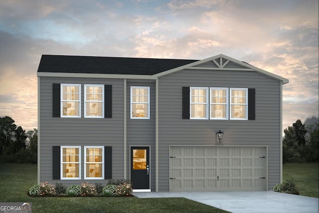 view of front of home featuring a garage and a yard