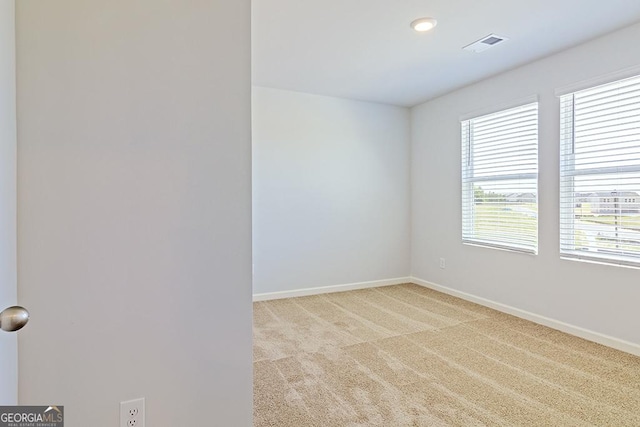 empty room featuring light carpet