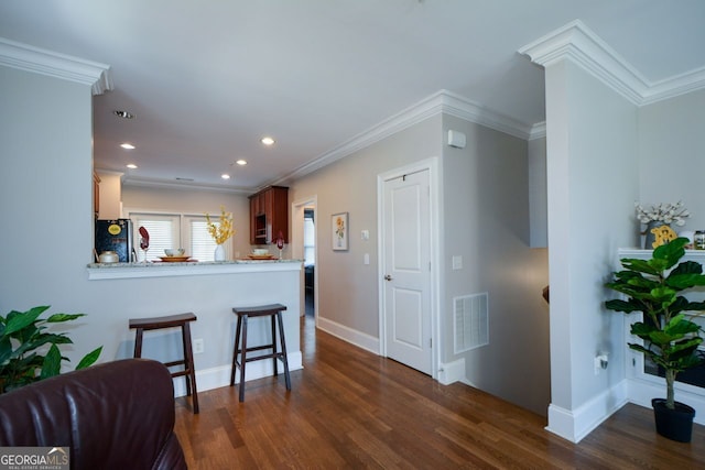 6422 Paulson, Atlanta, GA 30328 - kitchen with visible vents, a breakfast bar, dark wood-type flooring, and freestanding refrigerator