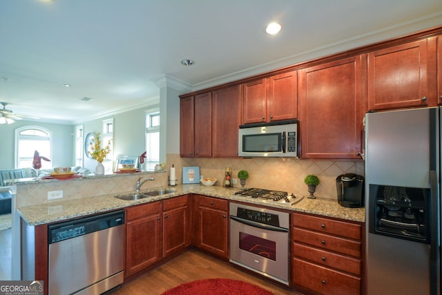6422 Paulson, Atlanta, GA 30328 - kitchen featuring decorative backsplash, appliances with stainless steel finishes, ornamental molding, a sink, and a peninsula