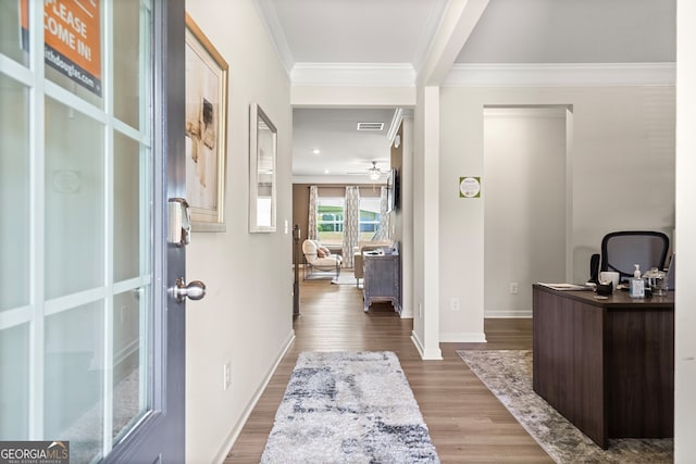 office featuring wood-type flooring, ornamental molding, and ceiling fan