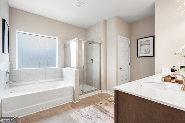 bathroom featuring vanity, plus walk in shower, and tile patterned flooring