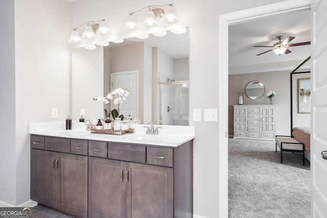 bathroom featuring vanity, an enclosed shower, and ceiling fan