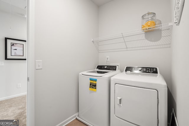 washroom featuring light colored carpet and washer and dryer