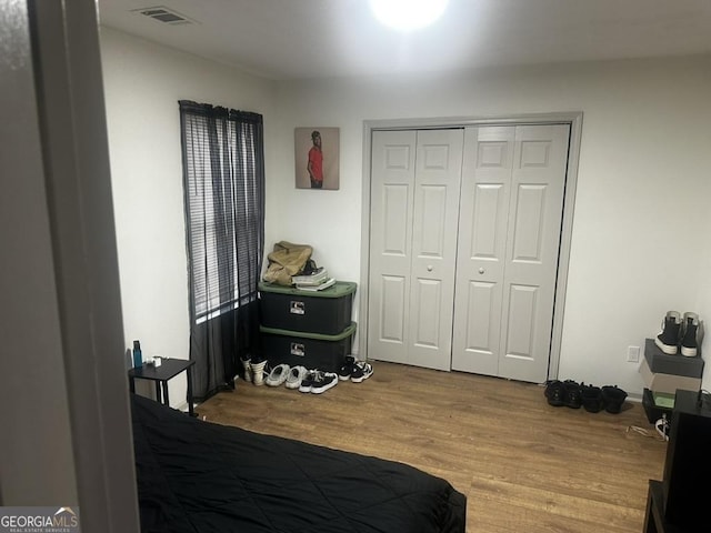 bedroom featuring light hardwood / wood-style floors and a closet