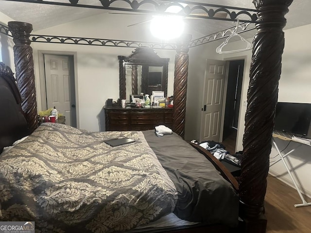 bedroom featuring lofted ceiling, hardwood / wood-style floors, and ceiling fan