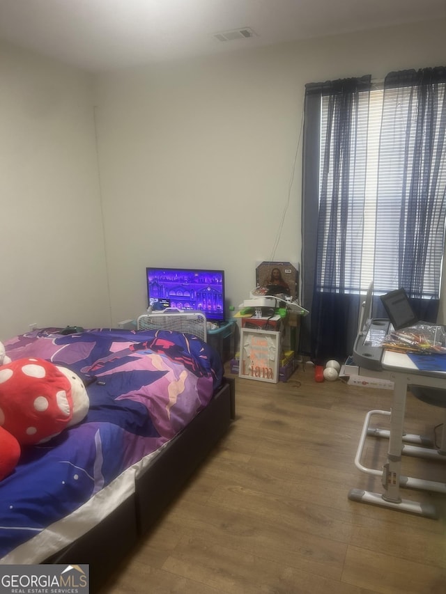 bedroom featuring wood-type flooring