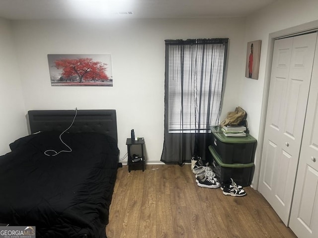 bedroom with hardwood / wood-style flooring and a closet