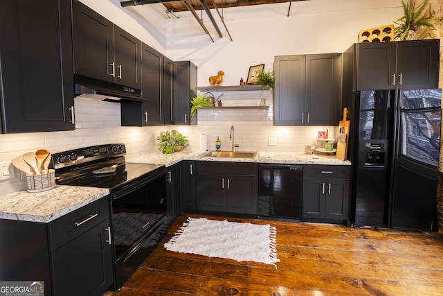 kitchen with sink, black appliances, tasteful backsplash, and light stone counters