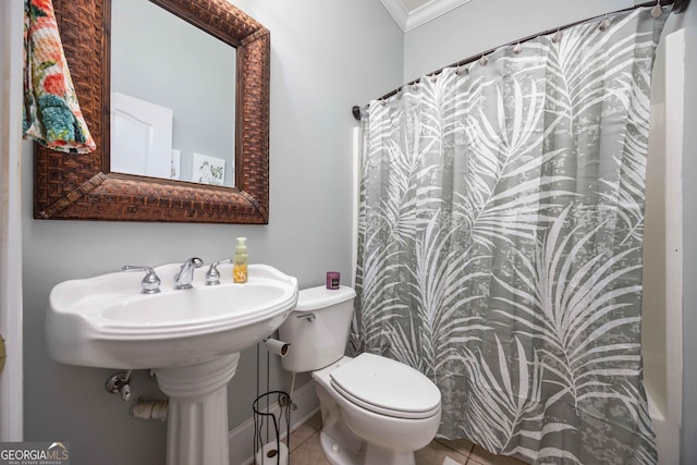 bathroom with crown molding, tile patterned floors, and toilet