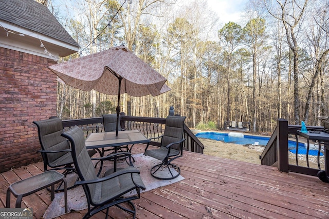 deck featuring a fenced in pool