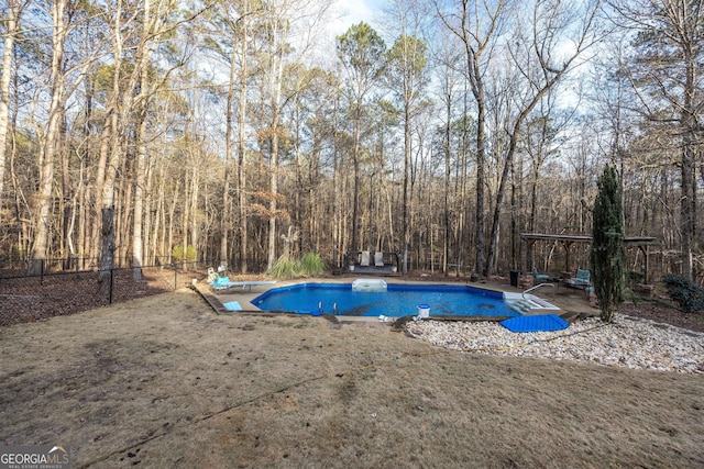 view of pool with a yard and a diving board