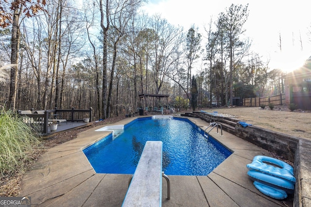 view of pool featuring a patio and a diving board