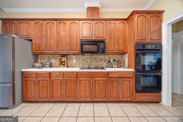 kitchen featuring crown molding, light tile patterned floors, decorative backsplash, and black appliances