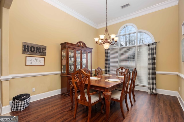 dining space with ornamental molding, a chandelier, and dark hardwood / wood-style flooring