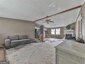 interior space with lofted ceiling and ceiling fan