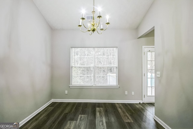 unfurnished dining area featuring dark hardwood / wood-style floors and a notable chandelier