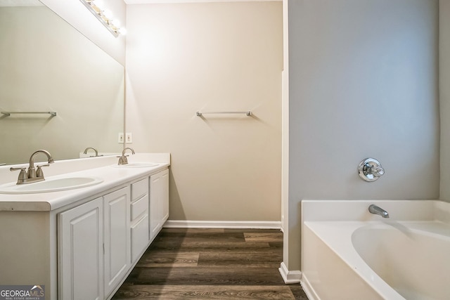 bathroom featuring vanity, a bathing tub, and hardwood / wood-style floors