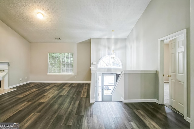 entryway with plenty of natural light, dark hardwood / wood-style floors, and a textured ceiling