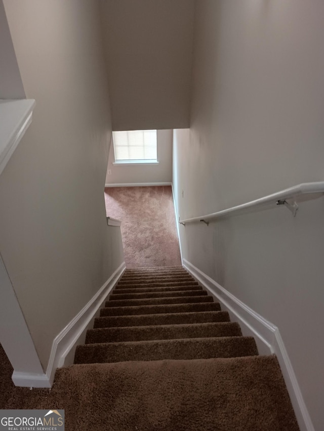 stairs featuring carpet floors and baseboards