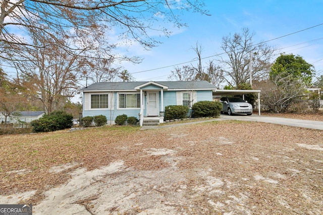 single story home featuring a carport