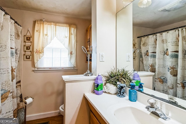 bathroom featuring hardwood / wood-style flooring, vanity, and toilet