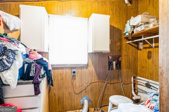 washroom with hookup for an electric dryer and wood walls