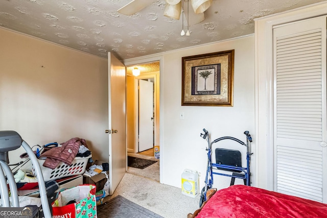 bedroom with carpet floors and a textured ceiling