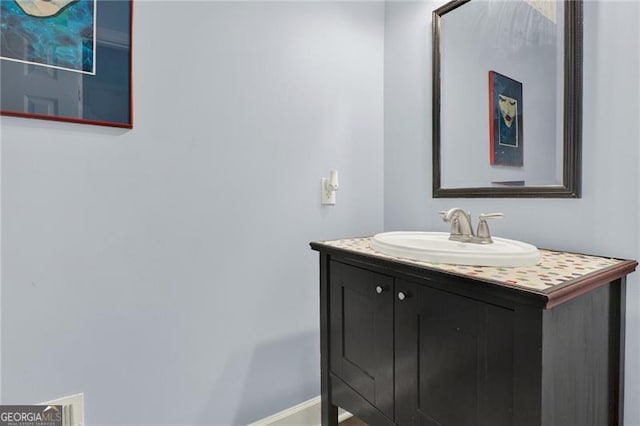 bathroom with vanity and baseboards