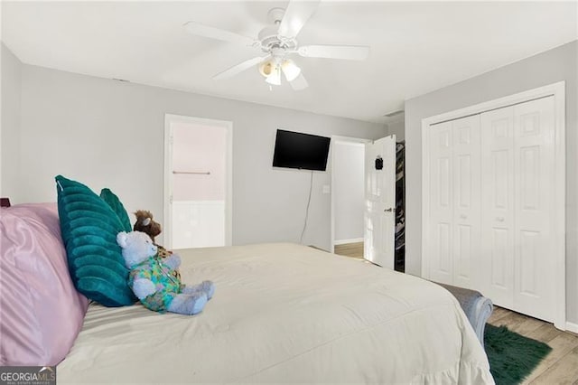 bedroom with a closet, ceiling fan, and light wood finished floors