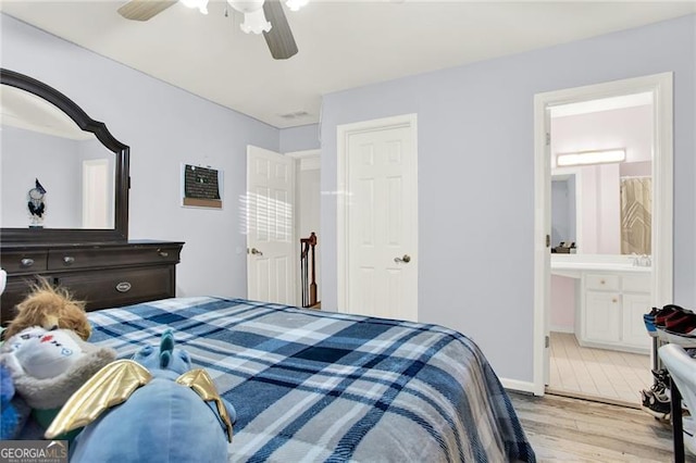 bedroom with ceiling fan, connected bathroom, and light wood-style floors