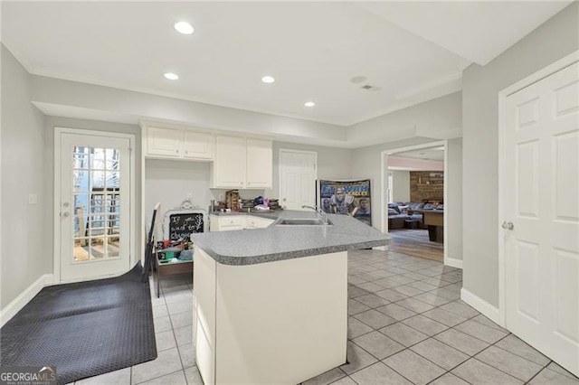 kitchen featuring recessed lighting, white cabinets, a sink, and light tile patterned flooring