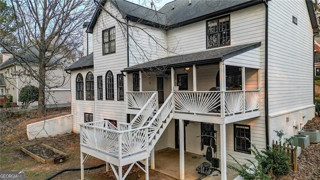 back of house featuring a patio area, a vegetable garden, and stairway