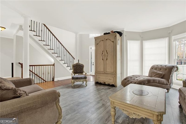 living room with ornamental molding, dark wood-style flooring, and decorative columns