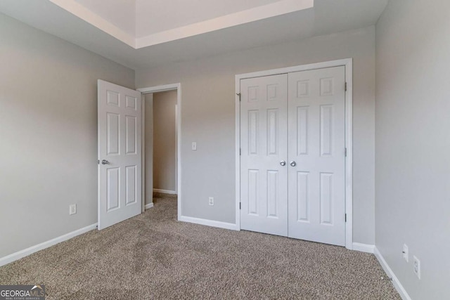 unfurnished bedroom with carpet floors and a closet